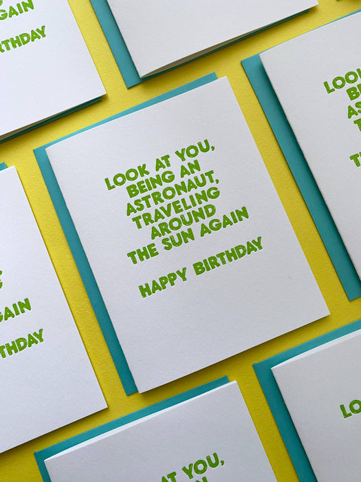 Astronaut Traveling Around the Sun Card