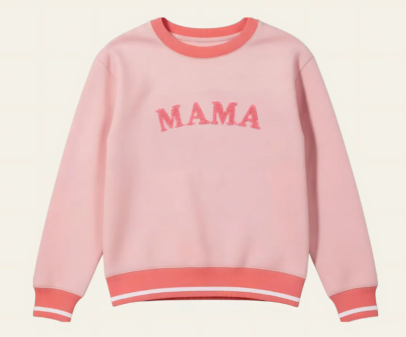 Pink sweatshirt with 'MAMA' text on a beige background